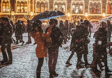 Busy and snowy cobbled street