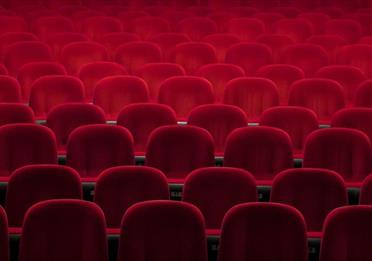 Empty red seats in a theatre