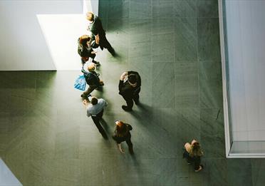 Top down view of people in grey space