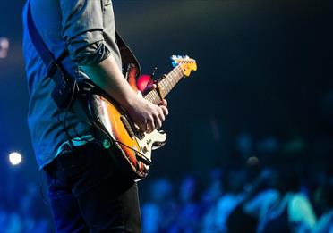 Guitarist playing to a large crowd