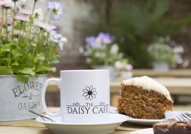 The Daisy Café mug and cake