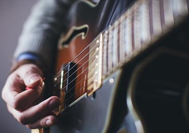 Person playing a guitar