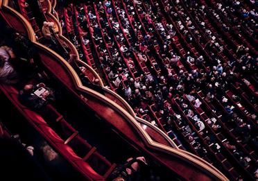 Audience sitting in a performance theatre