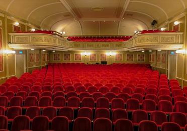 Empty red seats in a theatre