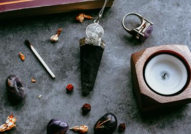 Crystals and candles on a grey marble surface