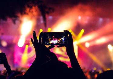 People at a concert taking pictures with phones