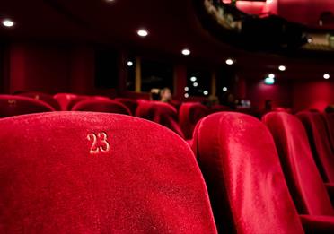 Red numbered seats at a theatre