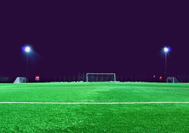 Empty football pitch at night with lights