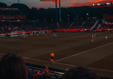 Football game at sunset in stadium