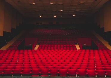 Empty red seats in a theatre