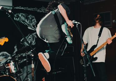 Guitarist jumping on stage