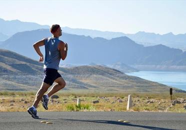 Person running on a scenic road