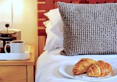 Bedside table - coffee and croissants