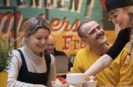 People being served a chocolate fondue