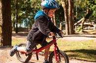 Child in the forest on his bike