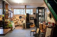 Room filled with antiques and collectables, furniture