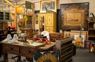 Room filled with antiques and collectables - art and furniture