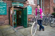 Cyclists with bicycle outside Saddles and Paddles store