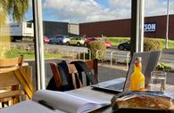 Laptop, notebook and food in front of laptop