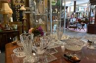 Room filled with antiques and collectables, glass