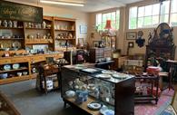 Room filled with antiques and collectables, china plates