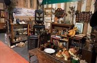 Room filled with antiques and collectables, books and ornaments