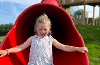 Girl on big red slide at Pennywell