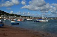 Teignmouth River Beach with boats all along it