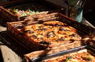 Square pizza served in a basket.