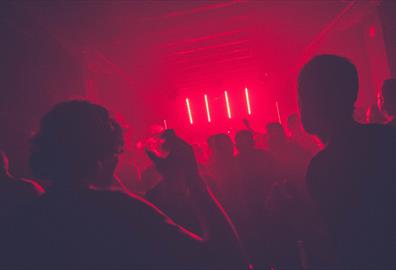 Dancing in red lit night club