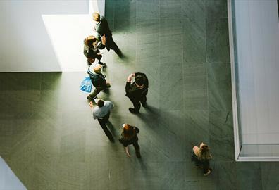 Top down view of people in grey space