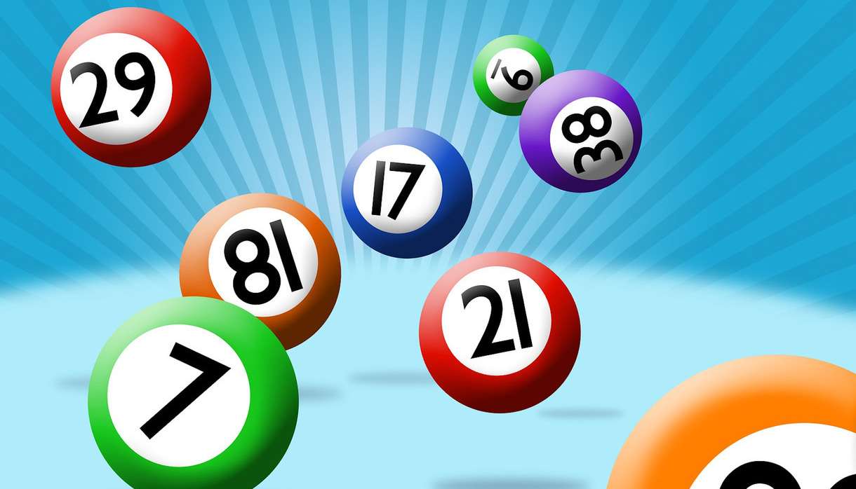 Colourful bingo balls across a bright blue background