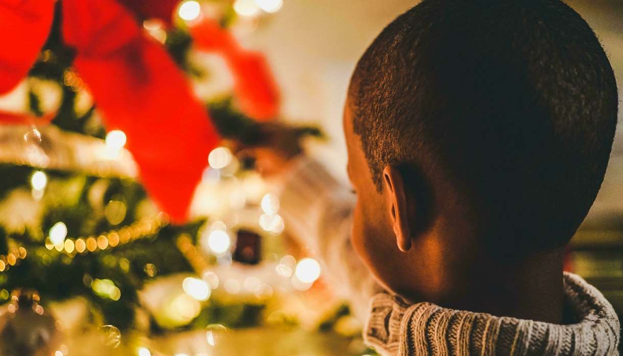 Small child close to Christmas tree