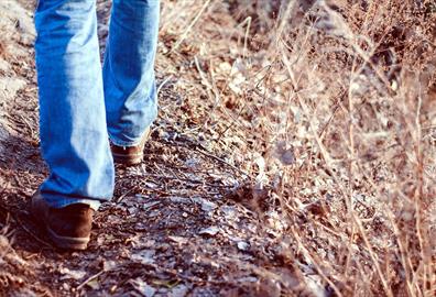 Person in jeans walking on a path