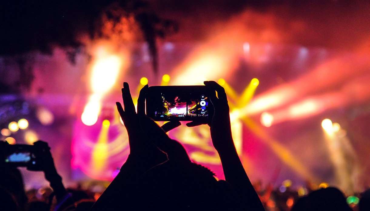 People at a concert taking pictures with phones