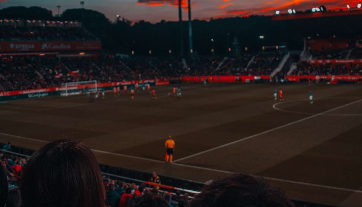 Football game at sunset in stadium