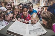 Children looking at a book in Devon & Exeter Institution