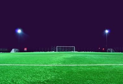 Empty football pitch at night with lights