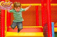 A child jumping in the indoor play area