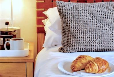 Bedside table - coffee and croissants