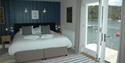 1st floor master bedroom with balcony and views direct to River Fowey. Zip and Link twin/superking bed