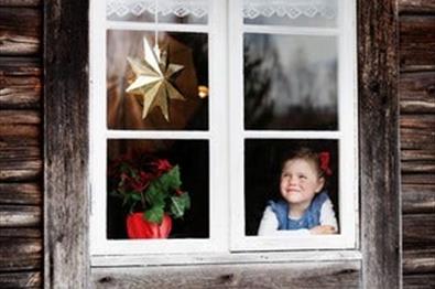Det er bildet av ei liten jente som sitter i vindu