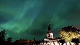 Eidsvoll church woth northern light in the sky 