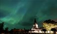 Eidsvoll church woth northern light in the sky