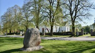 Eidsvoll church and the Eidsivathing stone marked 