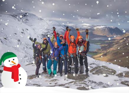 Visitors cheering atop a fell in the Lake District, Cumbria