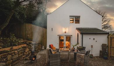 Outside seating and barbeque at Low Fold Holiday Cottages in Tallentire, Cumbria