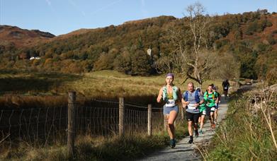 People running through the lake district