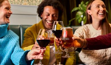 Guests enjoying drinks at The Ambleside Inn in Ambleside, Lake District