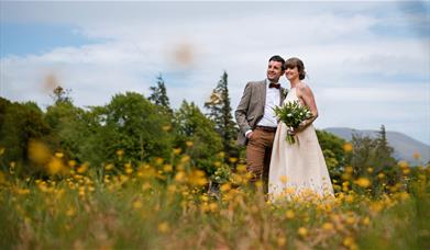 Happy Couple Posing for Wedding Photos at Armathwaite Hall Hotel and Spa in Bassenthwaite, Lake District